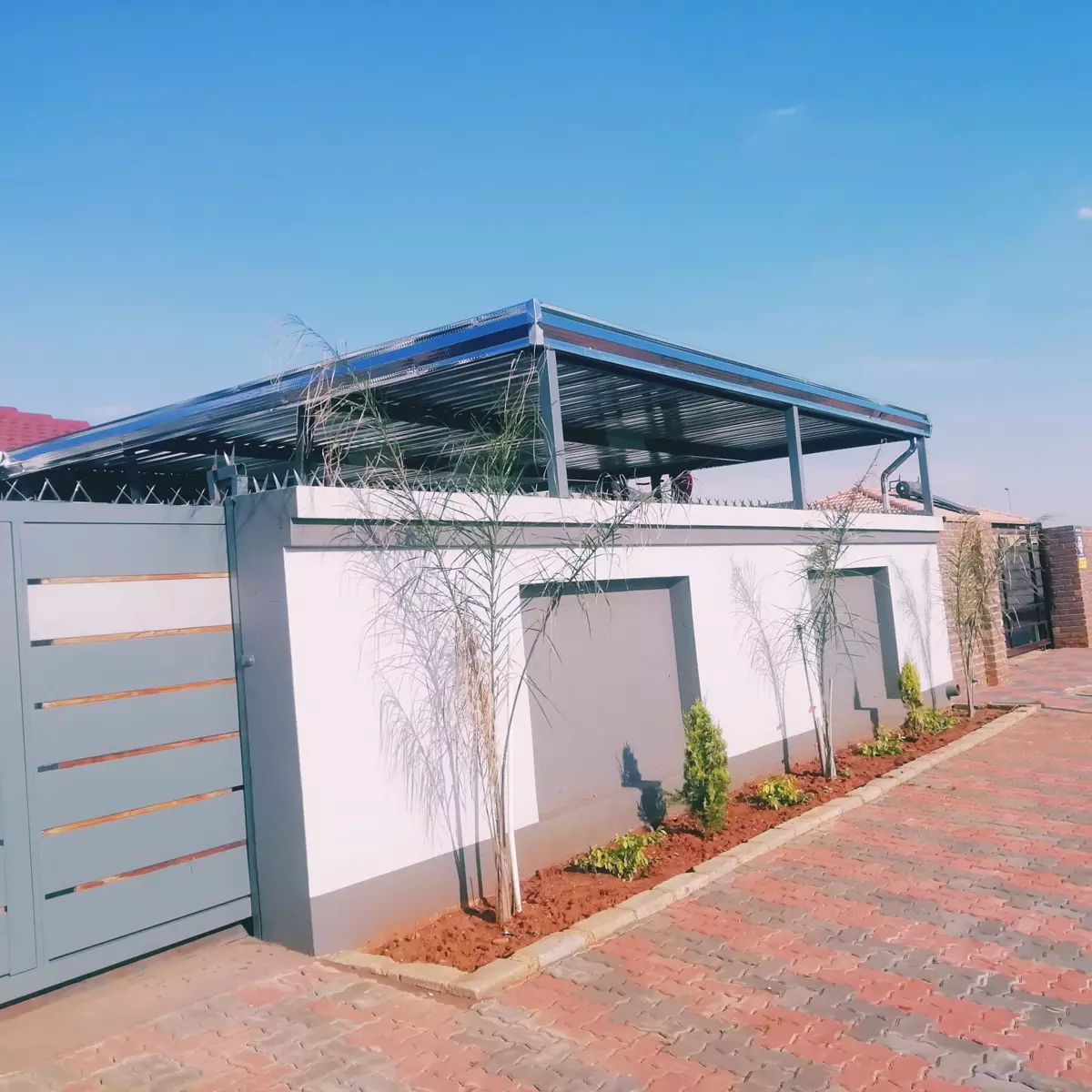 Carport above a boundary wall