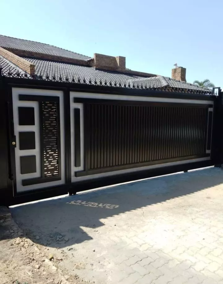 Black and white sliding gate made by QG Welding