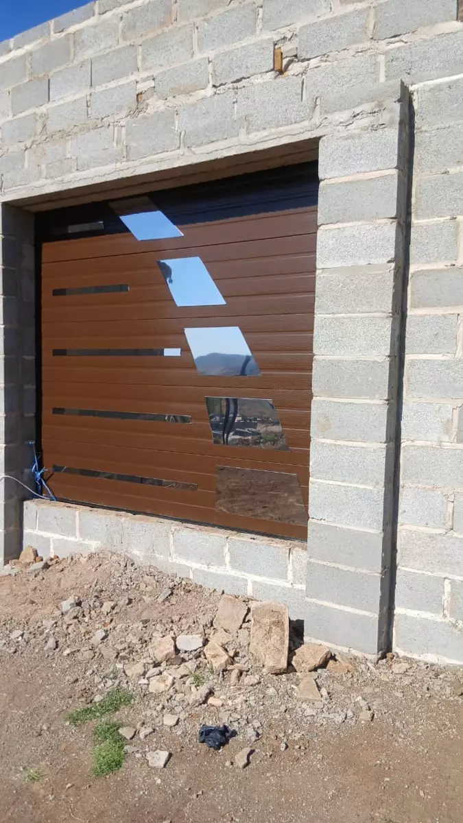 Sectional garage door with glass inserts