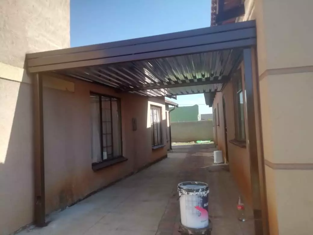 Carport covering a walkway between two houses